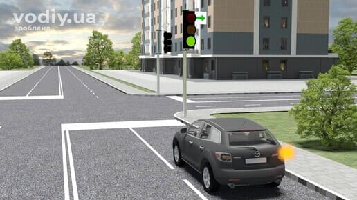 Чорний автомобіль з увімкненим правим покажчиком повороту перед перехрестям, зелений сигнал світлофора та табличка із зеленою стрілкою.