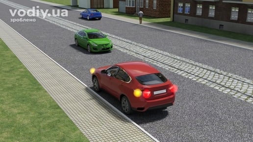 Зупинка автомобіля на лівому боці дороги з трамвайними коліями посередині в населеному пункті